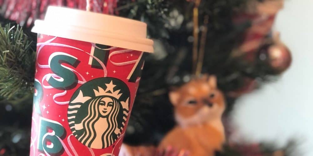 ornament made from a coffee cup hanging on a christmas tree
