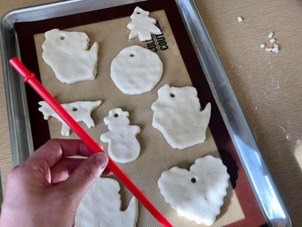 Verity of cute Christmas salt dough ornaments on cookie sheet ready to bake.