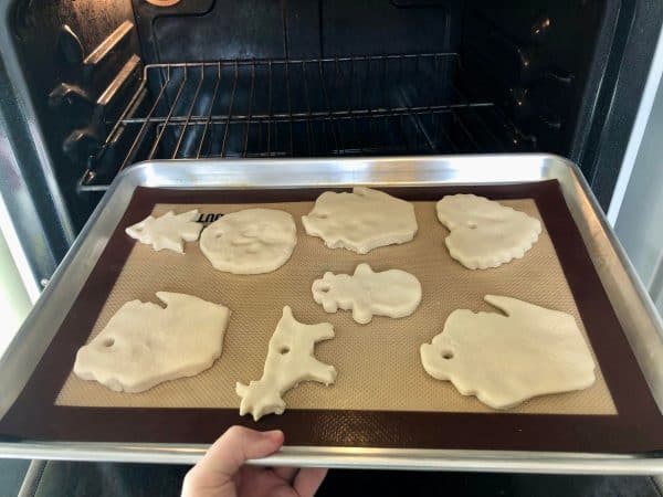 Verity of cute Christmas salt dough ornaments on cookie sheet ready to bake.