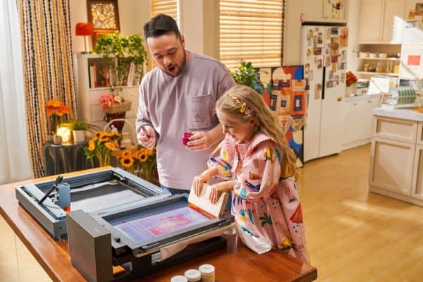Father and daughter using the xTool Screen Printer to make colorful t-shirts