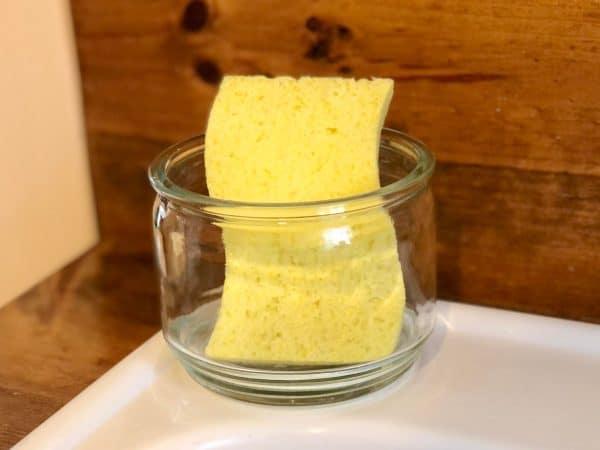 Repurposed sponge holder. DIY Sponge holder. How to repurpose candle jars DIY. How to use leftover candle wax. Repurpose empty candle jars. Upcycle. Trash to treasure.