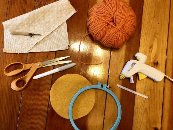 How to make a candle mat DIY. Candle mat DIY. Candle mat. Punch Needle DIY. Punch Needle project for beginners. Punch Needle ideas. crafting supplies. Acrylic yarn. Monks cloth. Hot glue gun. Embroidery Hoop. Fabric Scissors.