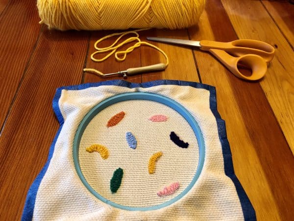 How to make a candle mat DIY. Monks cloth. Embroidery hoop. Painter's tape. Punch Needle project for beginners. Punch Needle ideas. Acrylic Yarn. Punch Needle.