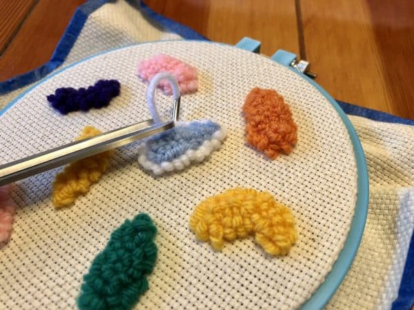 How to make a candle mat DIY. Monks cloth. Embroidery hoop. Painter's tape. Punch Needle project for beginners. Punch Needle ideas. Acrylic Yarn. Punch Needle.