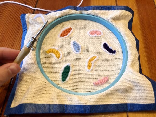 How to make a candle mat DIY. Monks cloth. Embroidery hoop. Painter's tape. Punch Needle project for beginners. Punch Needle ideas. Acrylic Yarn. Punch Needle.