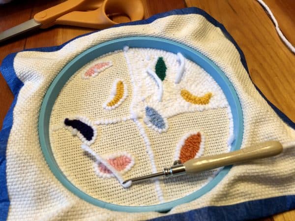 How to make a candle mat DIY. Monks cloth. Embroidery hoop. Painter's tape. Punch Needle project for beginners. Punch Needle ideas. Acrylic Yarn. Punch Needle.