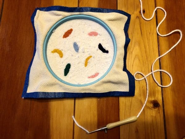 How to make a candle mat DIY. Monks cloth. Embroidery hoop. Painter's tape. Punch Needle project for beginners. Punch Needle ideas. Acrylic Yarn. Punch Needle.