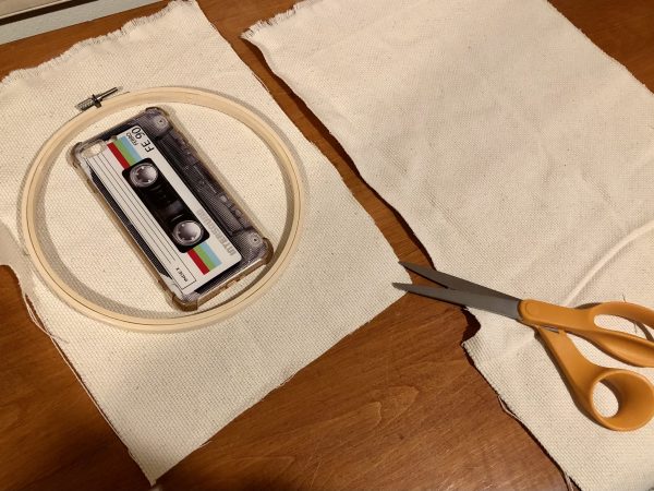 Steps for adorable DIY phone pad made by a punch needle with acrylic yarn.  Punch needle. Punch needle kit. Embroidery Hoop. Monks cloth. Fabric Scissors. Grey, Yellow, and White color scheme. Yarn crafts. Punch needle projects. Phone holder on desk. DIY phone holder.