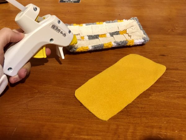 Steps for adorable DIY phone pad made by a punch needle with acrylic yarn.  Punch needle. Punch needle kit. Embroidery Hoop. Monks cloth. Fabric Scissors. Grey, Yellow, and White color scheme. Yarn crafts. Punch needle projects. Phone holder on desk. DIY phone holder.