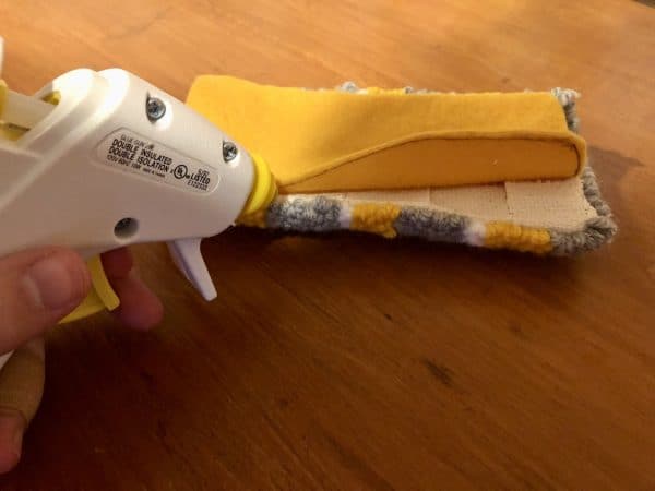 Steps for adorable DIY phone pad made by a punch needle with acrylic yarn.  Punch needle. Punch needle kit. Embroidery Hoop. Monks cloth. Fabric Scissors. Grey, Yellow, and White color scheme. Yarn crafts. Punch needle projects. Phone holder on desk. DIY phone holder.